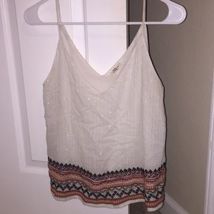 white tank with pattern on bottom